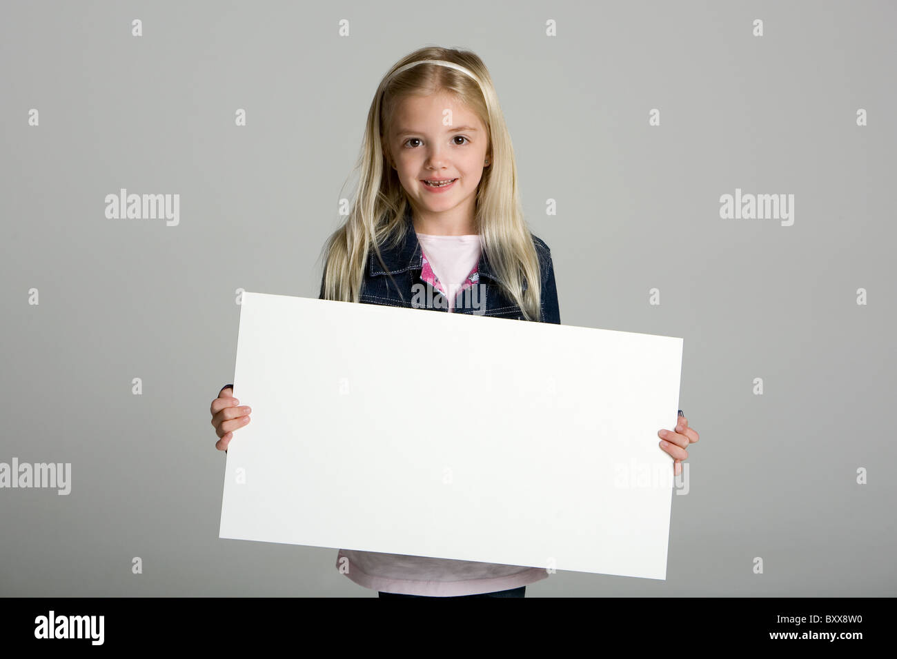 Happy little girl holding a blank sign Stock Photo Alamy