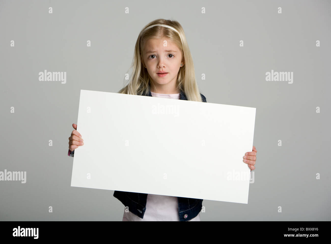 Cute little girl holding a blank sign Stock Photo Alamy