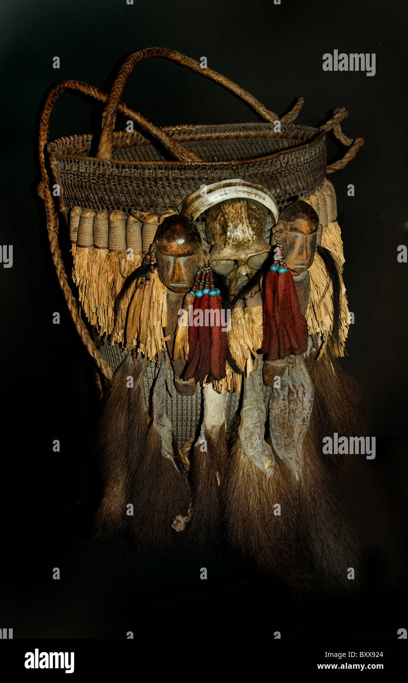 Assam India 20th Cent ceremonial basket decorated with skull monkey and two carved human heads Stock Photo