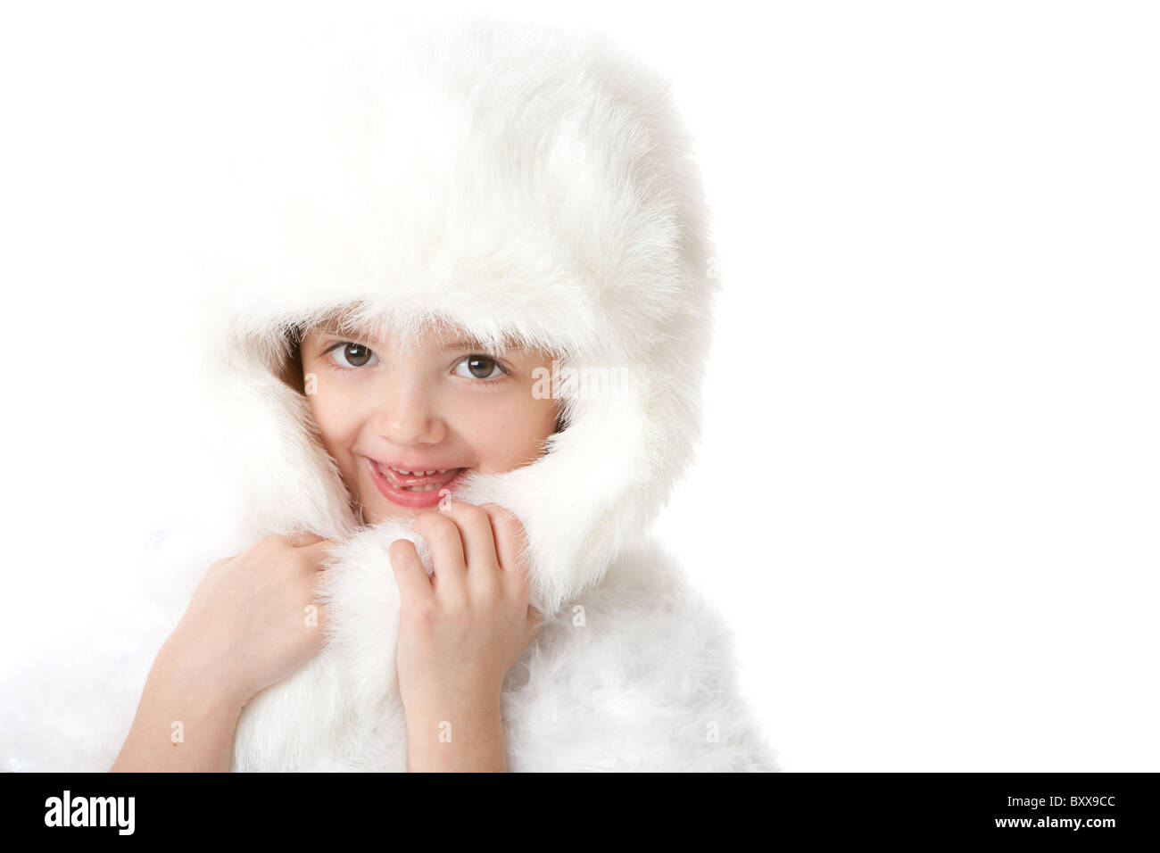 cute little girl smiling, wearing a white fur coat and hat Stock Photo ...