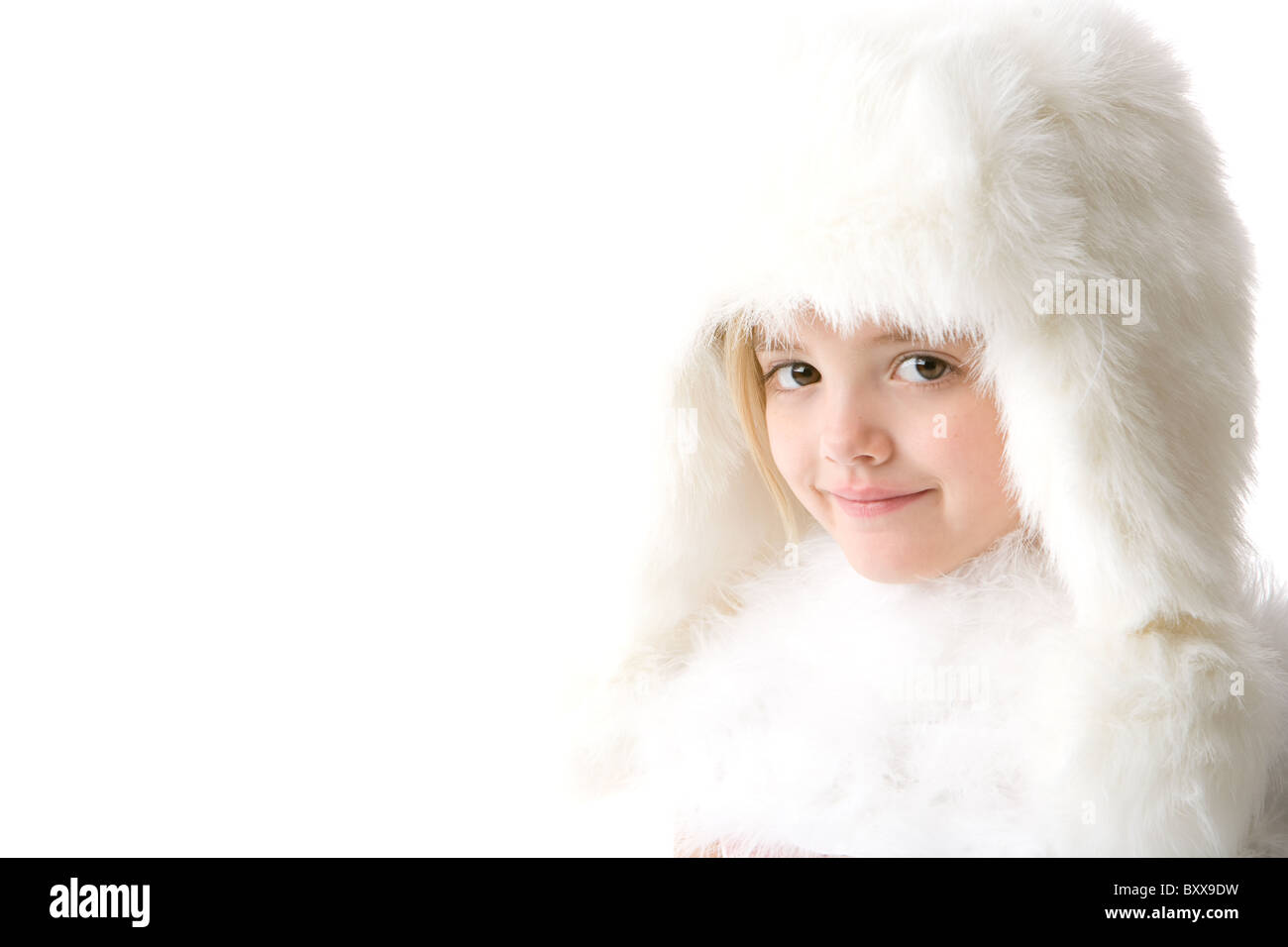 cute little girl wearing a white fur coat and hat isolated on white ...