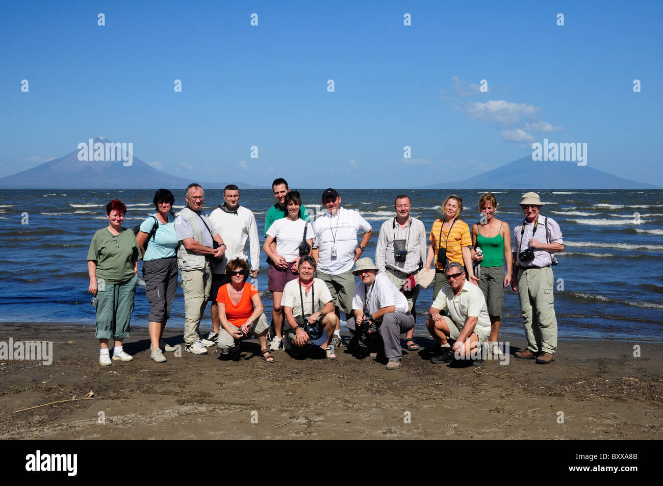 Group of tourists in from of Lake Nicaragua, Concepcion and Maderas Volcano, Nicaragua, Central America Stock Photo