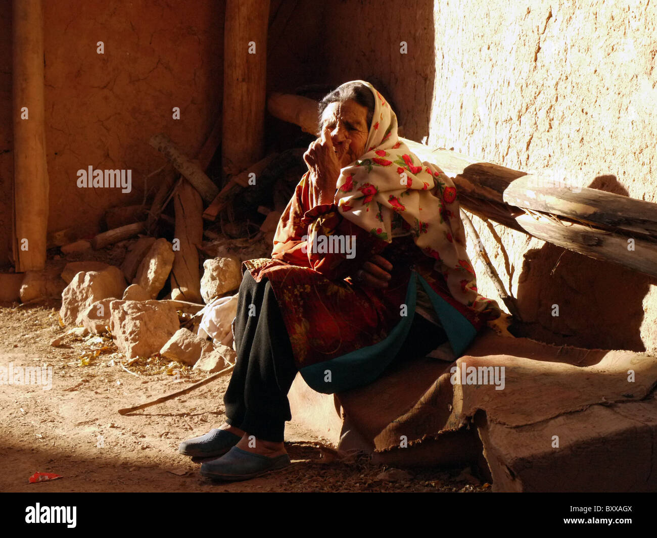 Women in traditional clothing sitting outside a house,  Abyaneh Iran Stock Photo