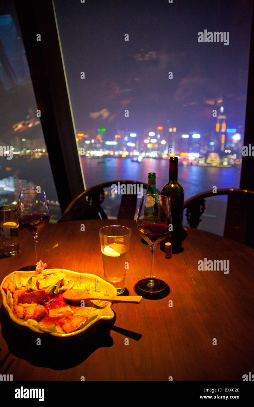 Looking out of the window of Aqua's Hutong restaurant meal and wine in view No 1 Peking Road off Nathan Road Stock Photo
