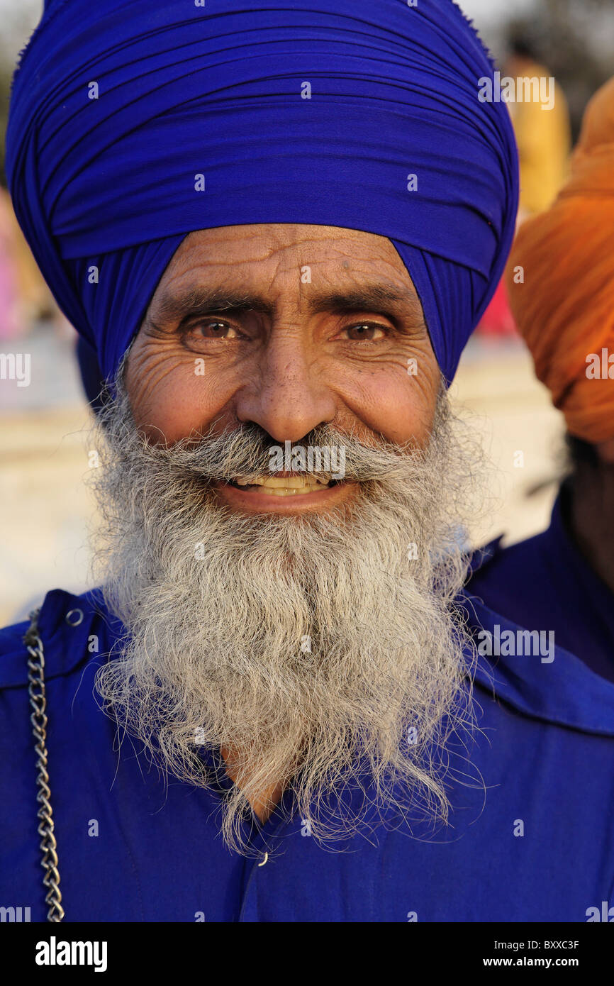 Colorful sikh dressed in blue and The Taj Mahal, a mausoleum located in ...