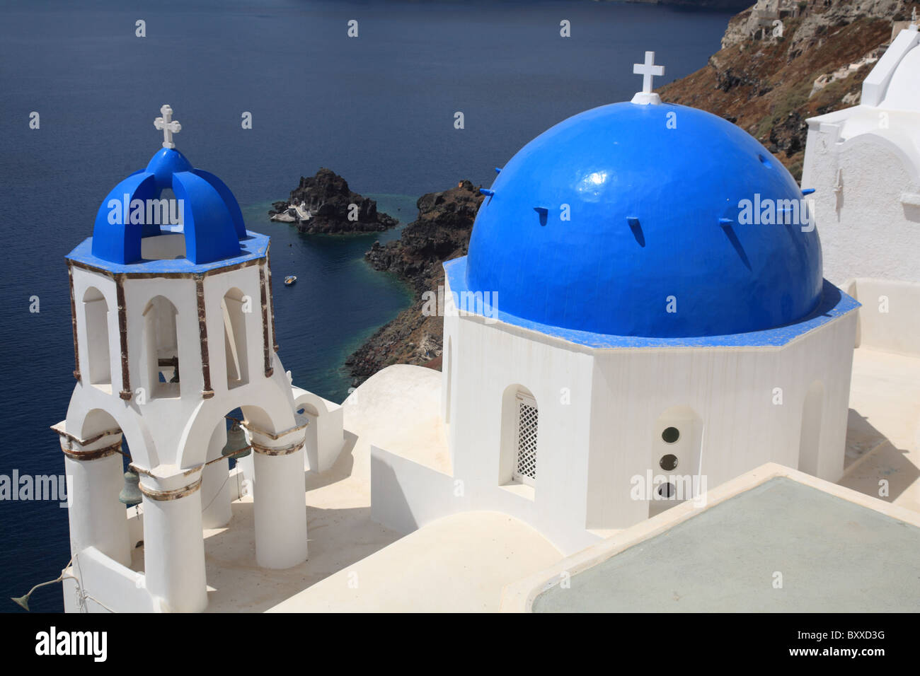 Blue Dome Greek church and bell tower, Oia village, Santorini, Cyclade Islands, Greece Stock Photo