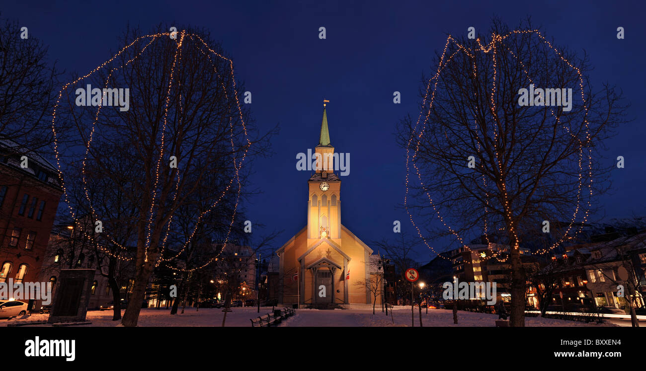 The cathedral Tromsø Domkirke in the city centre of Tromsø, North Norway. Trees are decorated for Christmas. Stock Photo