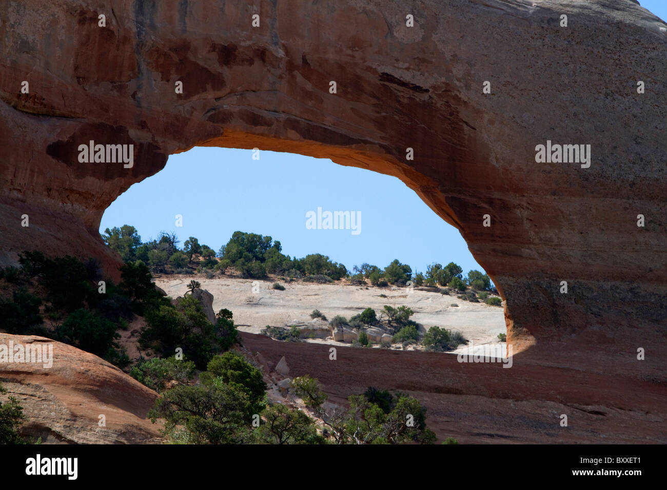 Wilson Arch is a natural sandstone arch along U.S. Route 191 near Moab, Utah, USA. Stock Photo