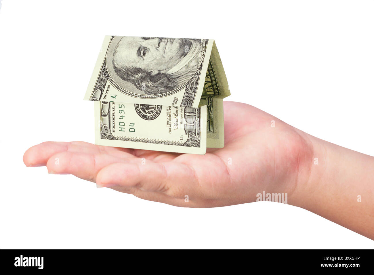 Kid's hand holding money house on white background Stock Photo