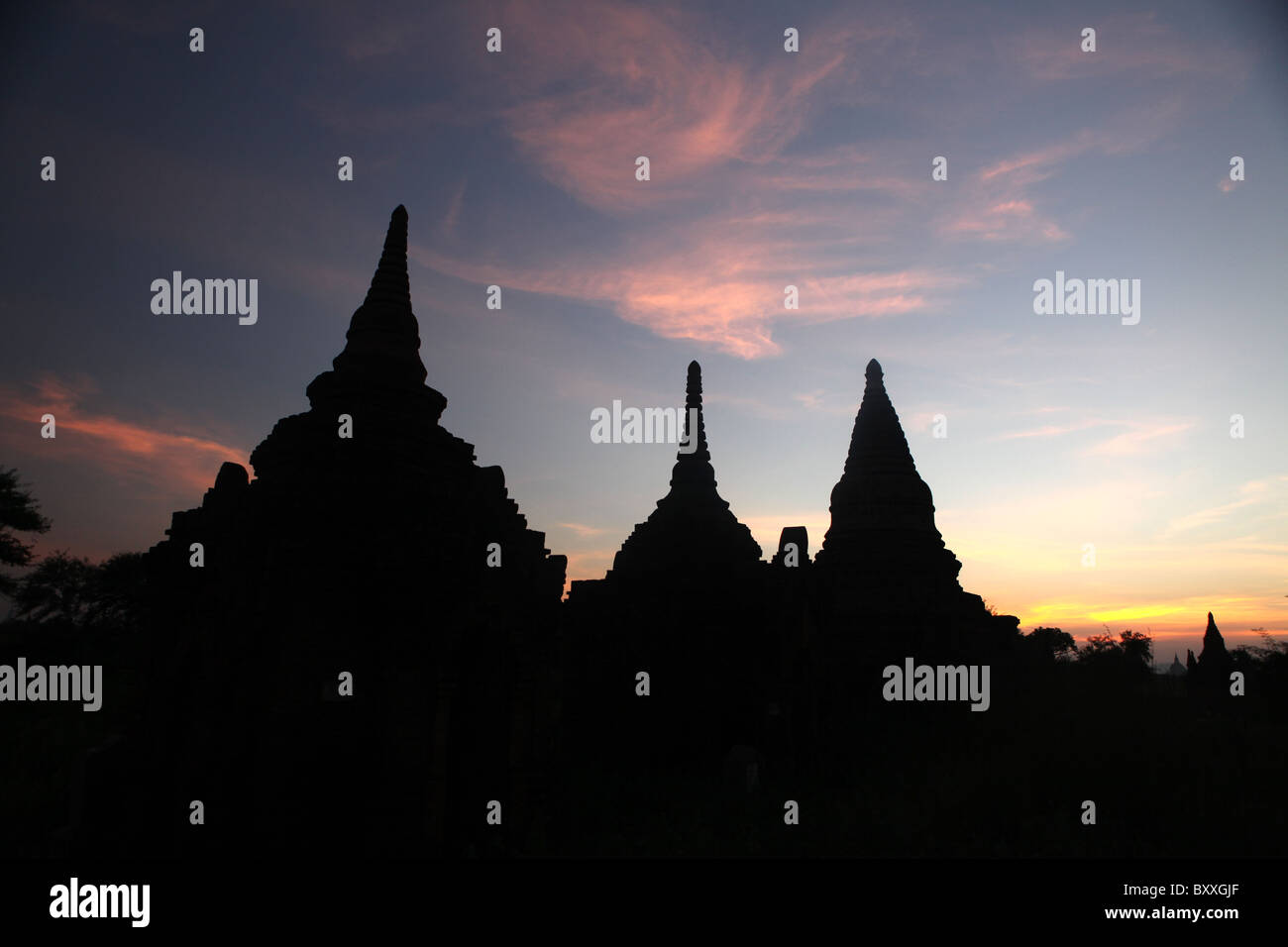 Silhouettes of Buddhist temples or pagodas at sunset in Bagan, Myanmar or Burma. Stock Photo