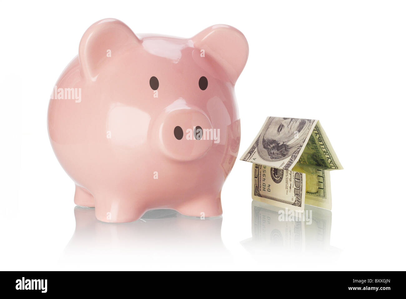 Piggy bank and money house on white backgound Stock Photo
