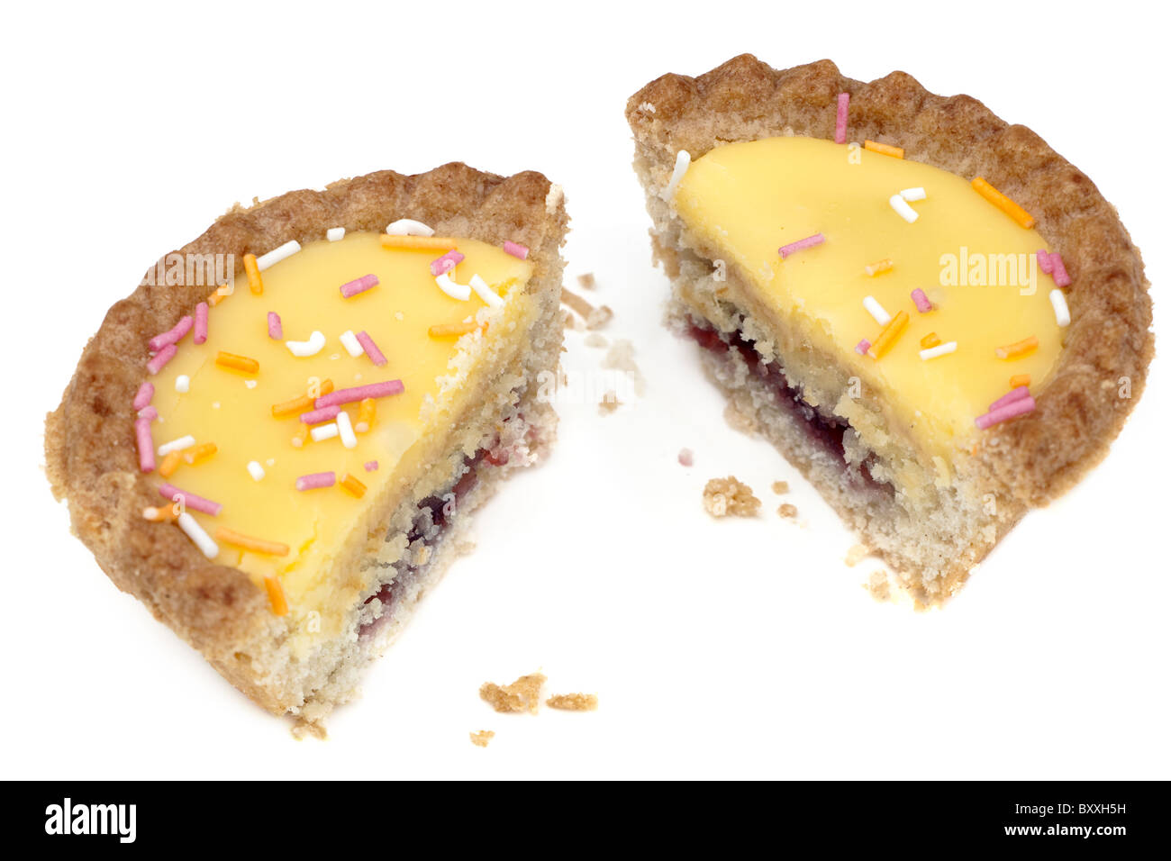 Halved bun with custard icing and jam filling Stock Photo