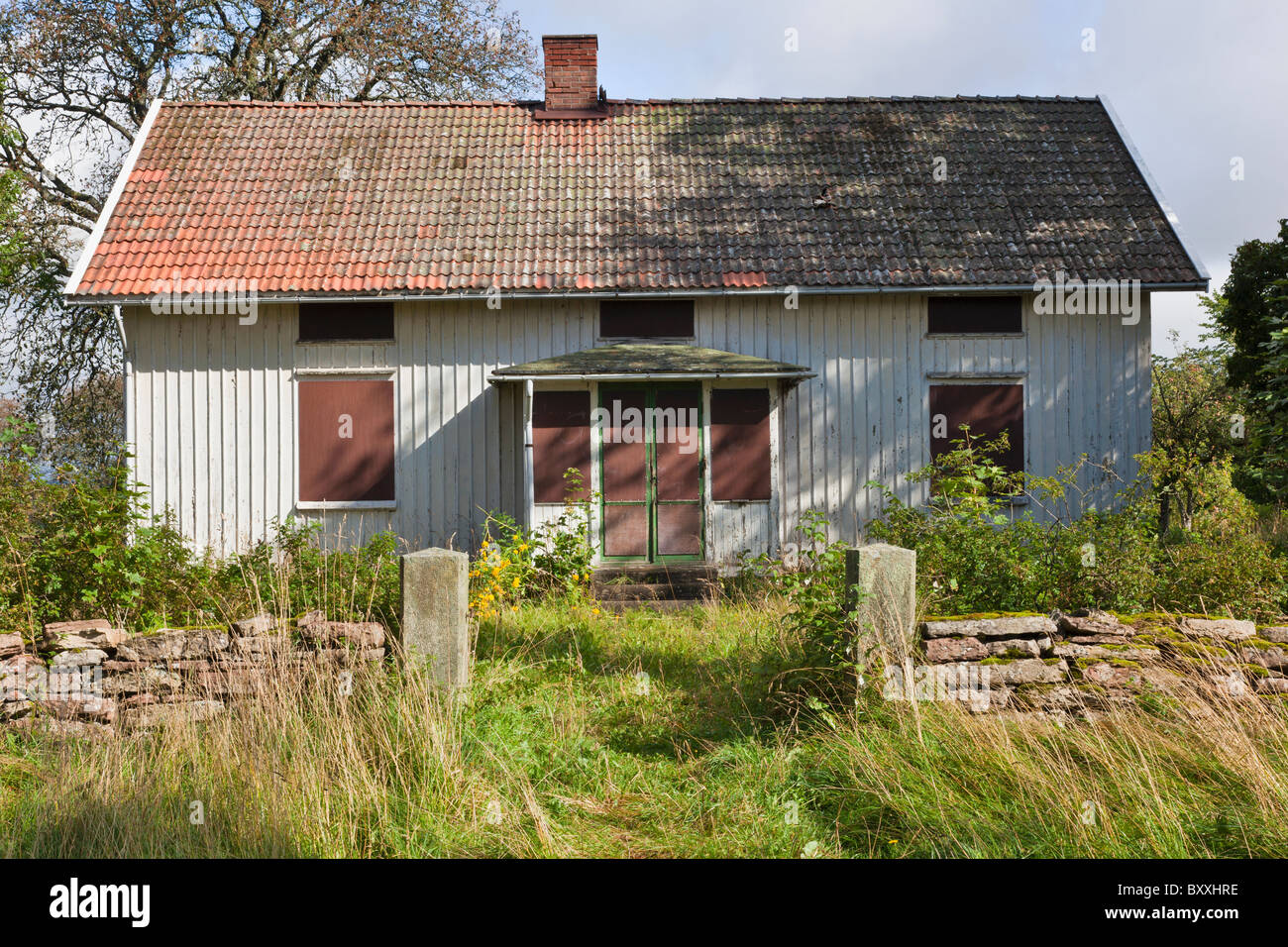 Old abandoned house with stone wall around the garden Stock Photo - Alamy