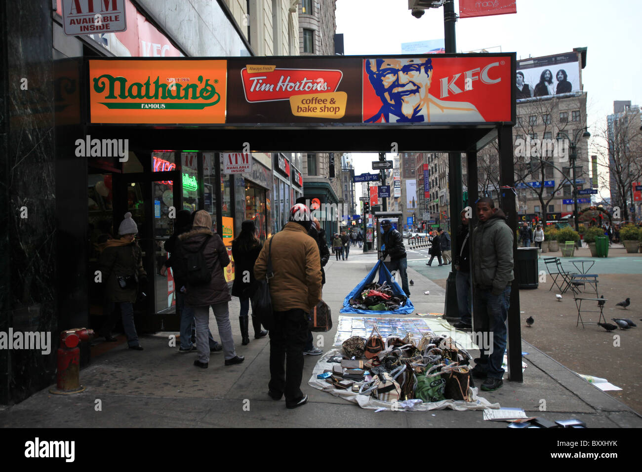 Counterfeit fake designer handbags on sale on sidewalk in New York city