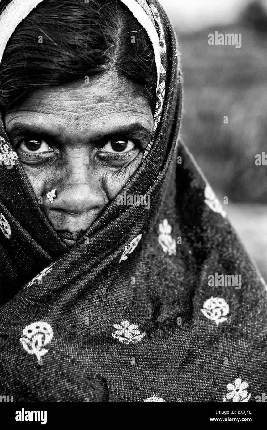 Indian woman wrapped in a shawl, keeping warm in winter. Andhra Pradesh, India. Monochrome Stock Photo