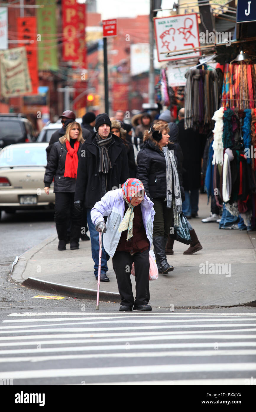 A very old Chinese woman crossing street in China town, New York city, 2010 Stock Photo