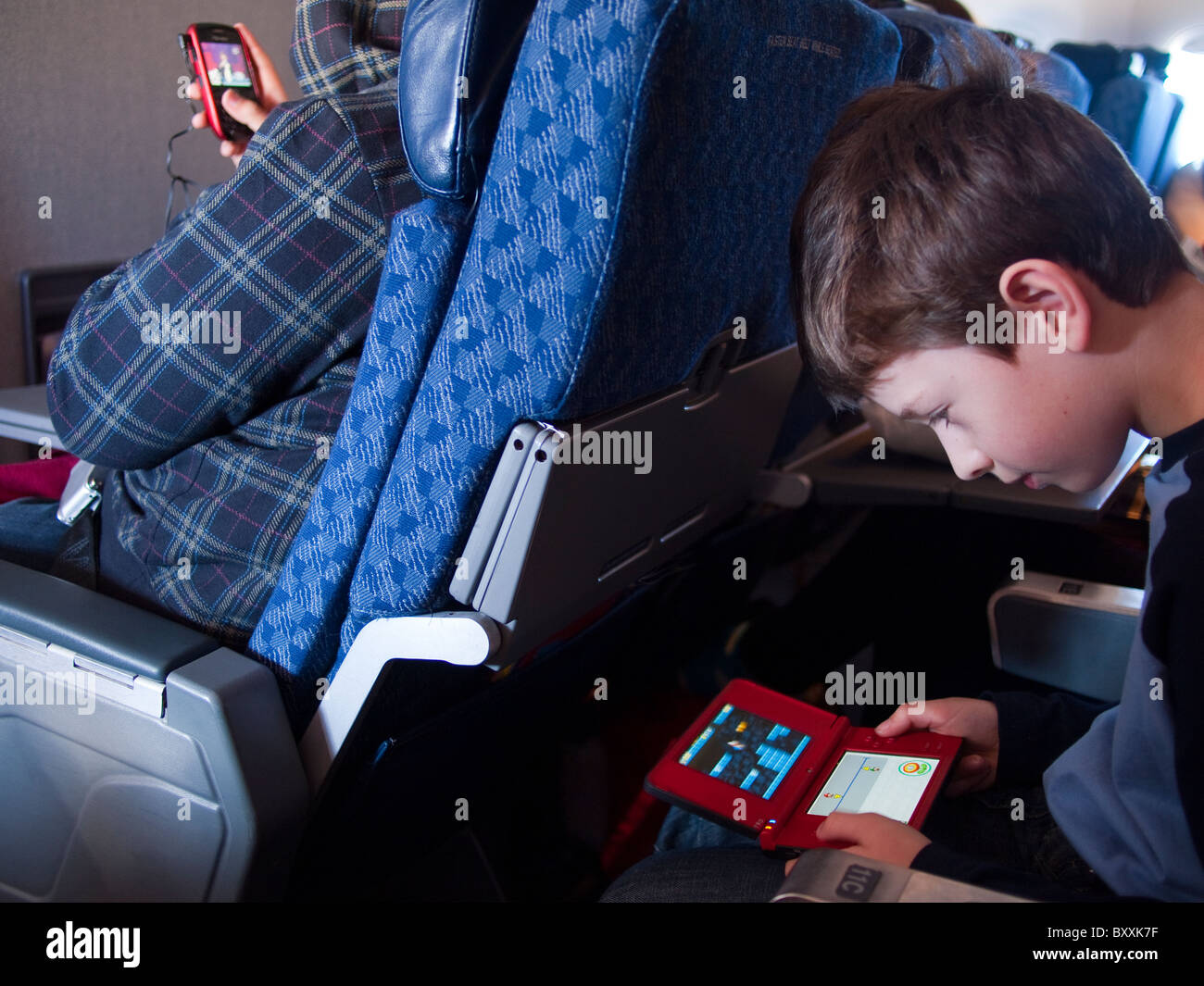 Boy Playing Nintendo DS on Plane Stock Photo Alamy