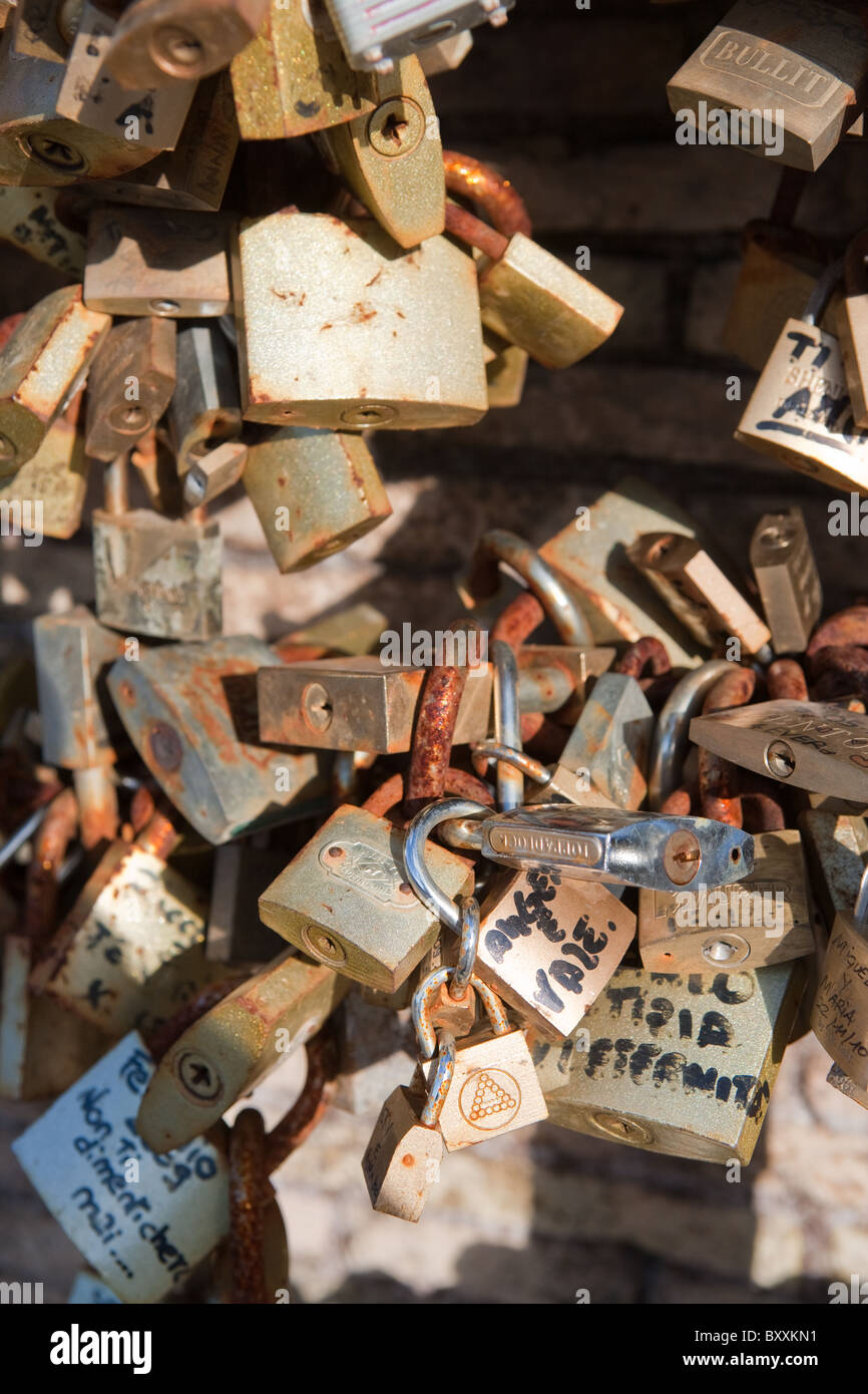 First love lock locks on the Milvio bridge chained to wall Rome Italy young teen lovers romantic movie italian style street Stock Photo