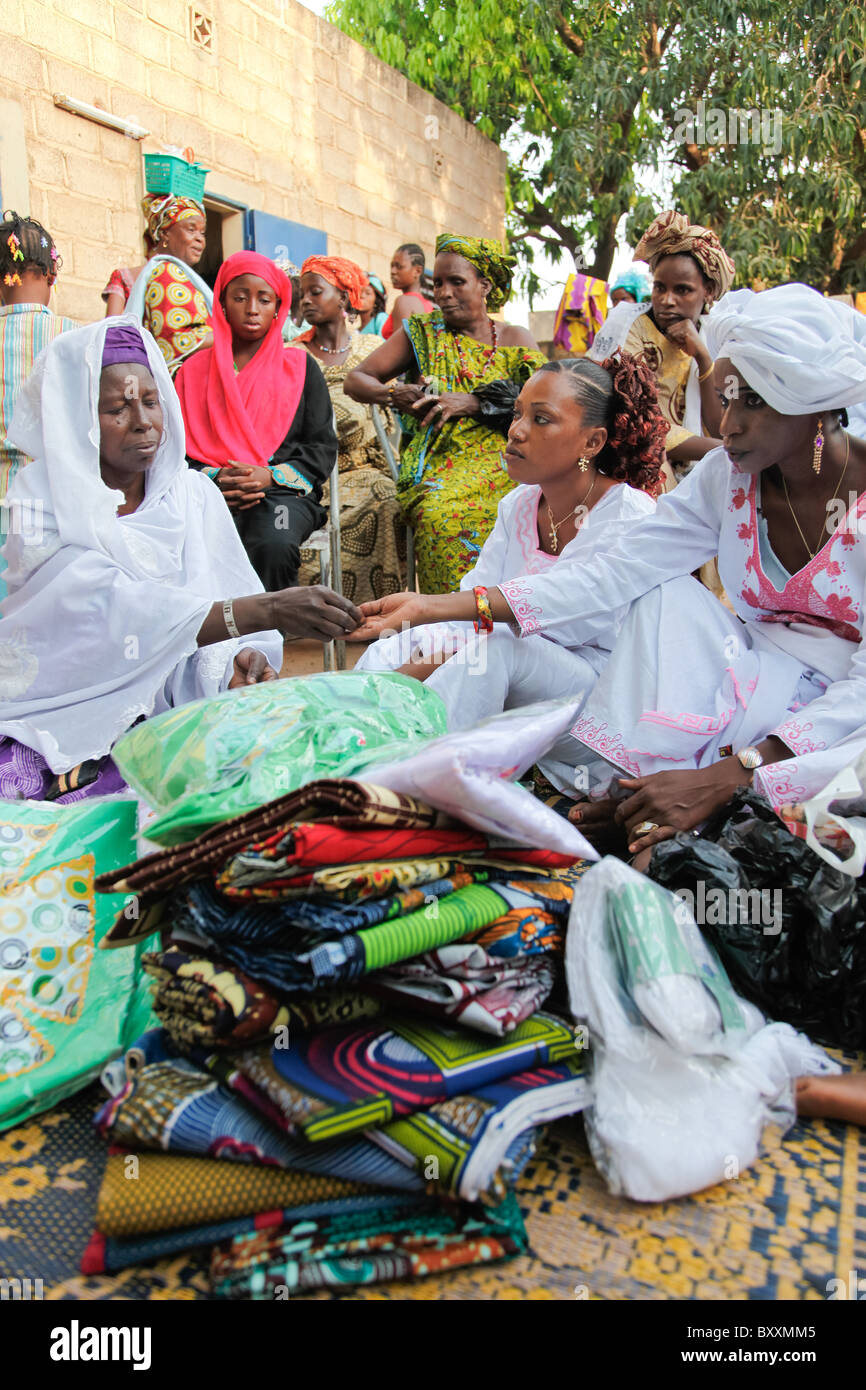 In Ouagadougou, Burkina Faso, women bring gifts of clothing to a child ...