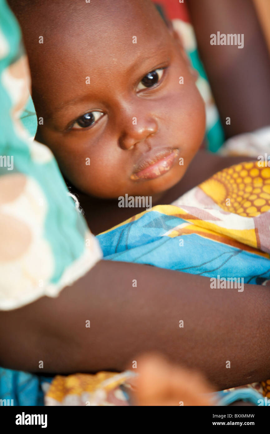 A Fulani woman holds her child at her home in Djibo in northern Burkina Faso, West Africa. Stock Photo