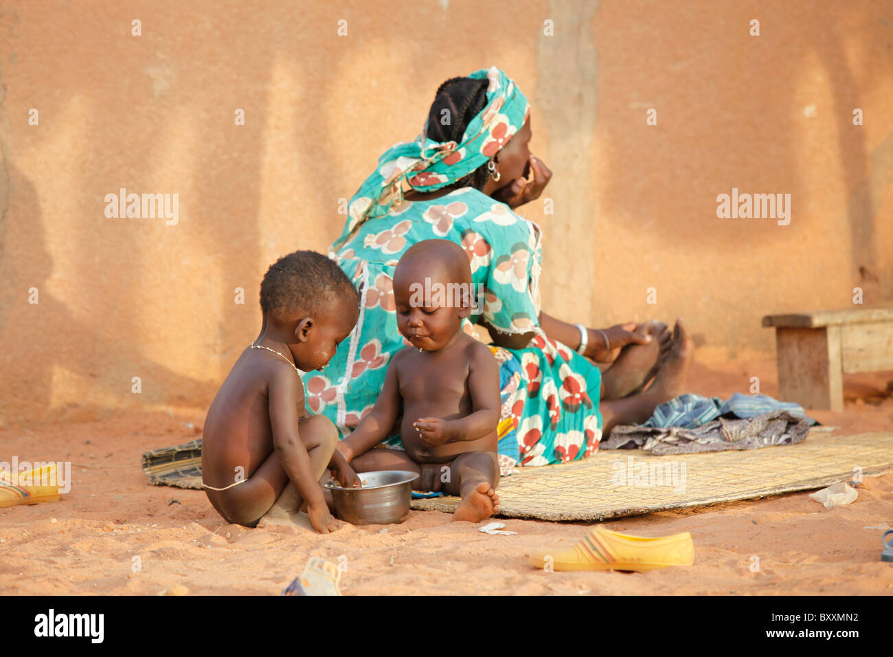 Two young Fulani children eat with their hands in Djibo in northern Burkina Faso, West Africa. Stock Photo