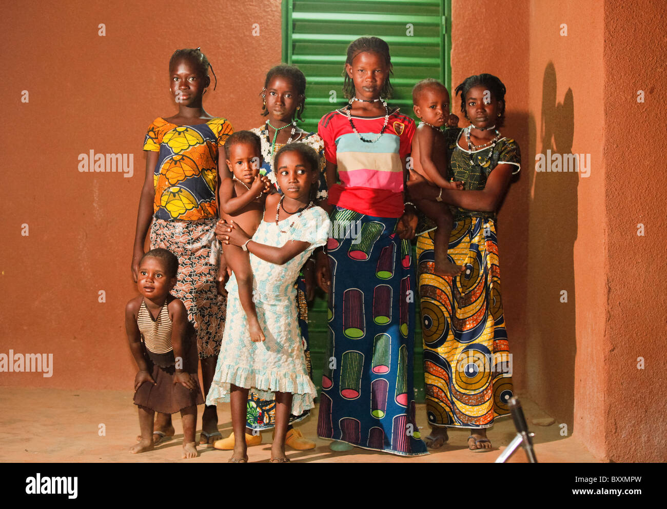 Young women and children line up for a nighttime photo in Djibo in northern Burkina Faso. Stock Photo