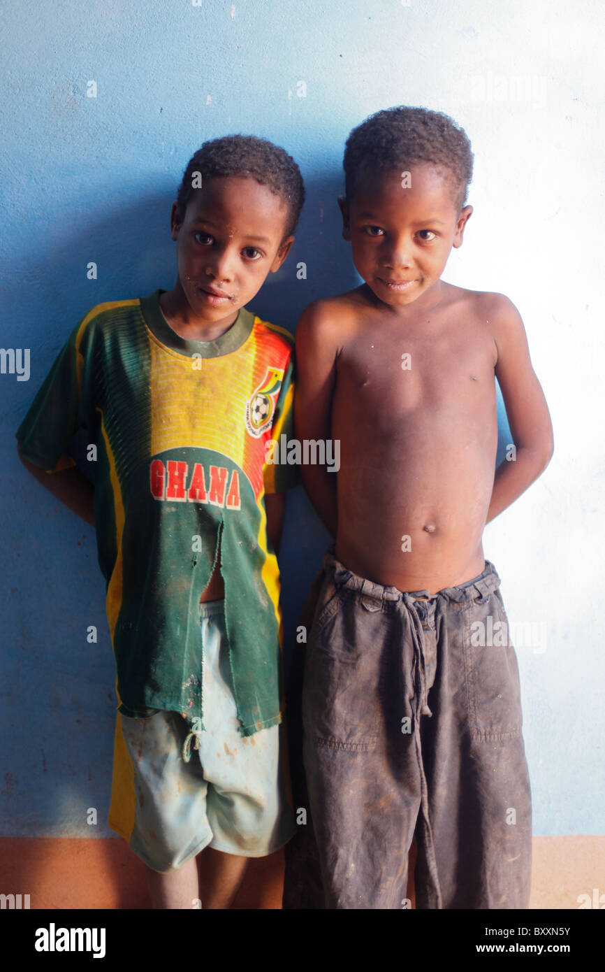 Two children stand against the wall of their house in Djibo, Burkina Faso. Stock Photo