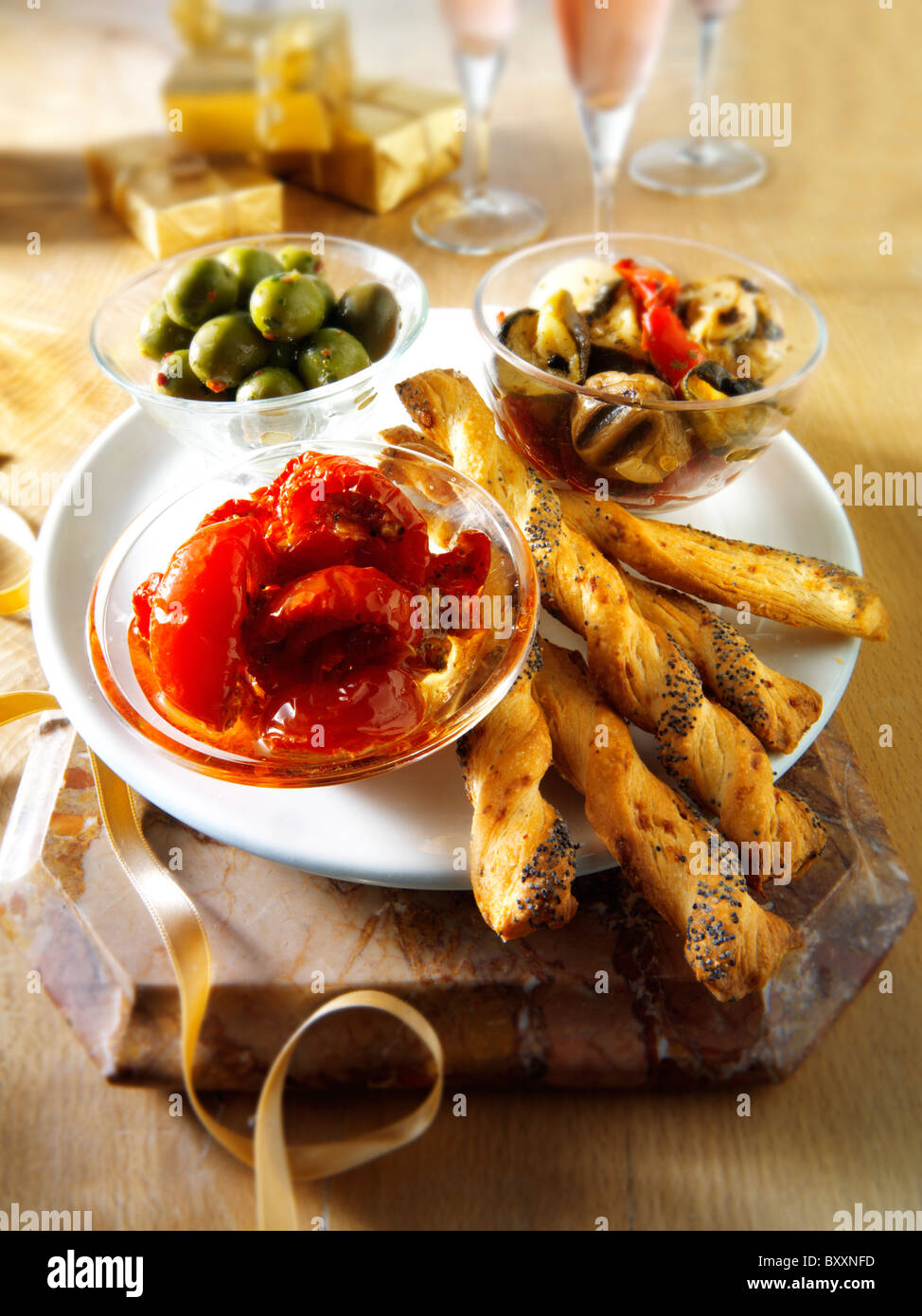 Italian party buffet food with sundried tomatoes, bread sticks, olives