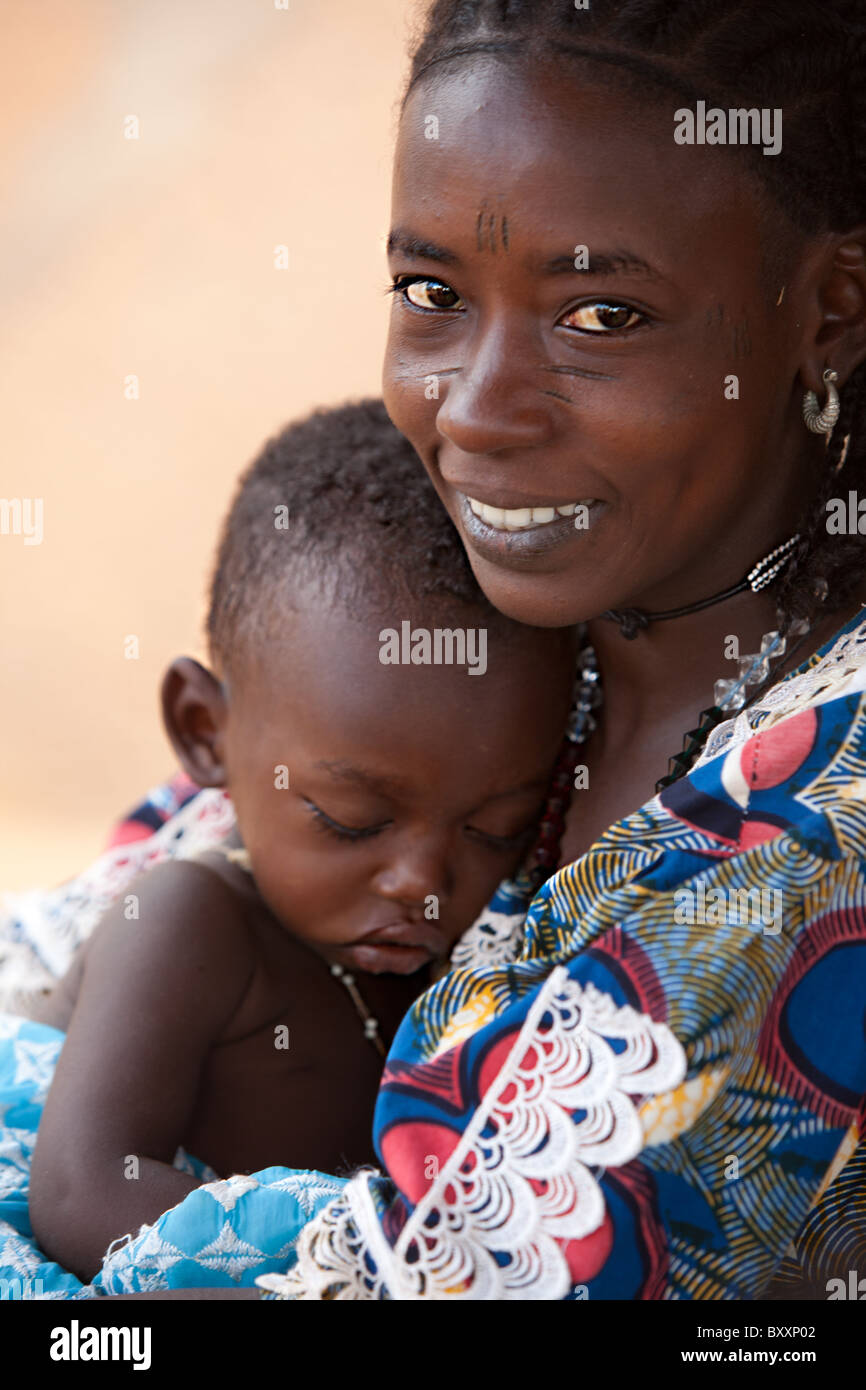 Fulani woman and child in Djibo in northern Burkina Faso. The woman sports the traditional facial scarring, that is considered b Stock Photo