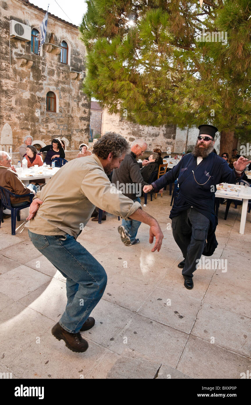 A priest and villagers dancing at a Panayiri, a local festival at Proastio in the outer Mani, Southern Peloponnese, Greece Stock Photo