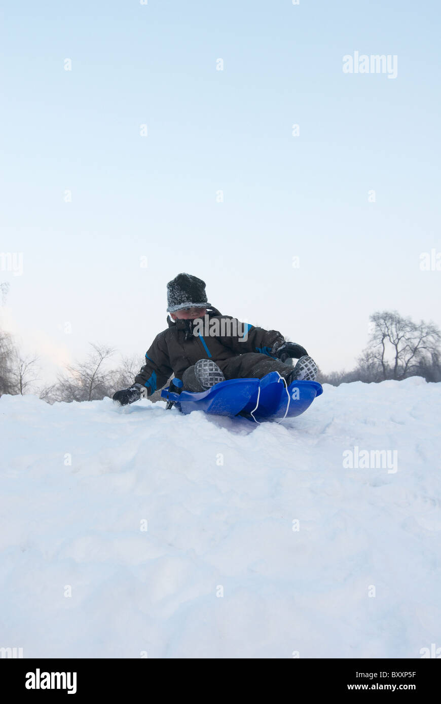 Children sledding on sled winter Stock Photo