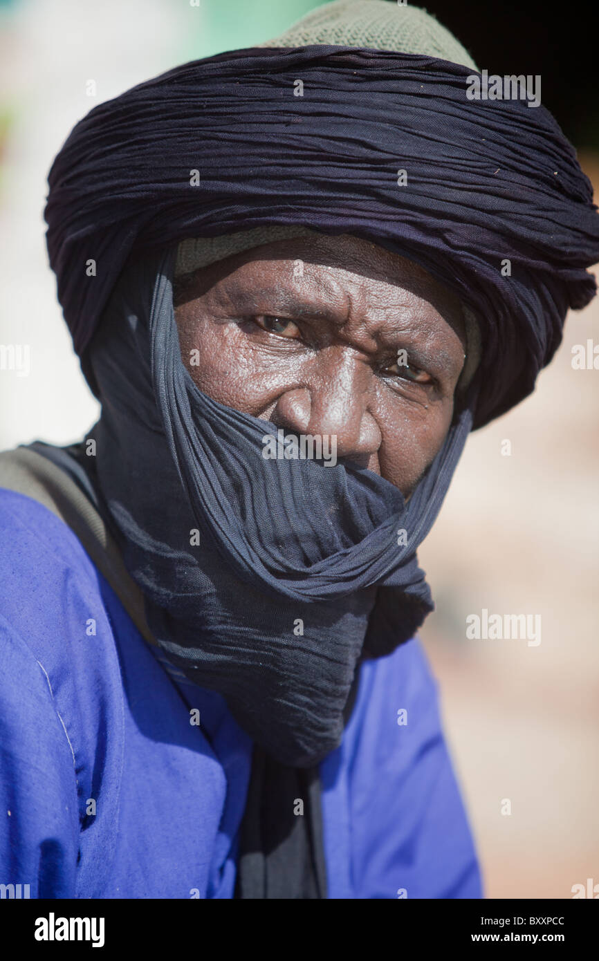 On the morning of Tabaski, a Touareg man heads to the great mosque of Djibo in Burkina Faso for a special Eid prayer. Stock Photo