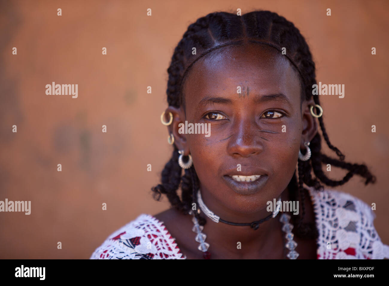 Fulani woman in Djibo in northern Burkina Faso. The woman sports the traditional facial scarring, that is considered beautiful. Stock Photo