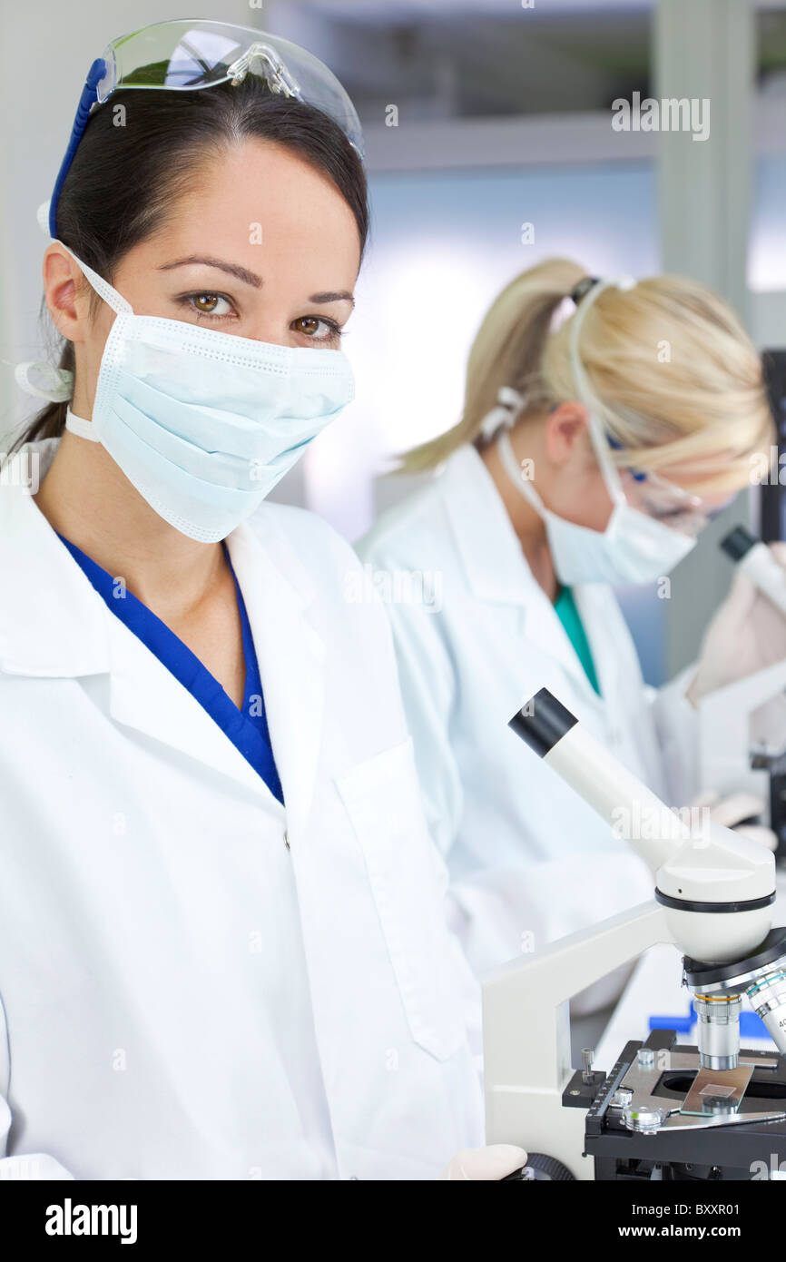 A female medical or scientific researcher or doctor using her ...