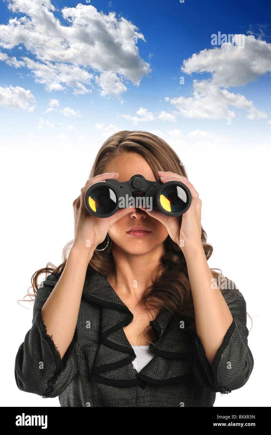 Beautiful businesswoman using binoculars with sky background Stock Photo