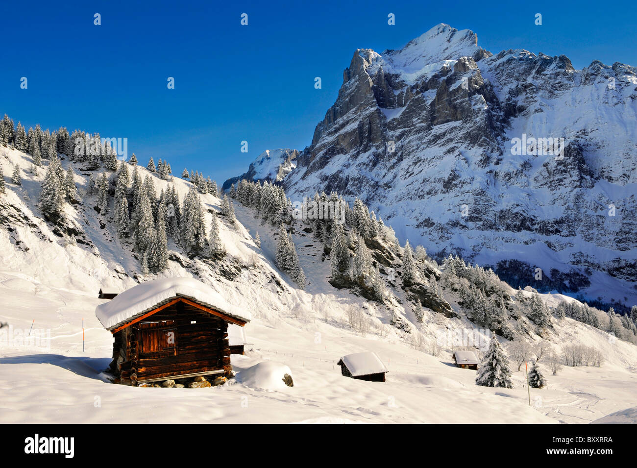 Mountain chalet in winter looking towards the wetterhorn mountain. Grindelwald, Swiss Alps Stock Photo