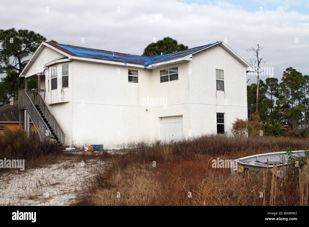Abandoned damaged and neglected home in West Palm Beach Florida due to