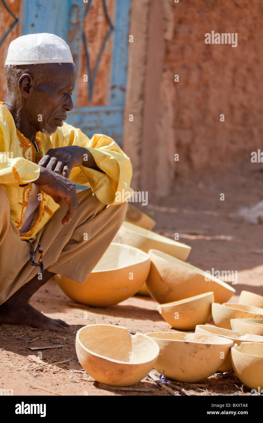 A man sells calabashes in the weekly market in Djibo, northern Burkina Faso. Stock Photo