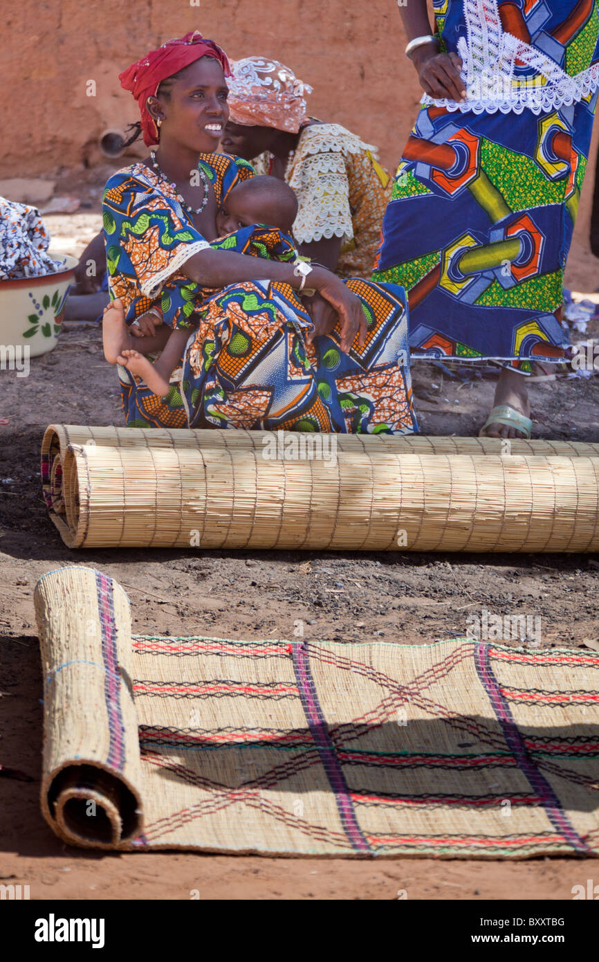 A Fulani woman sells handwoven straw mats at the weekly market in Djibo in northern Burkina Faso. Stock Photo