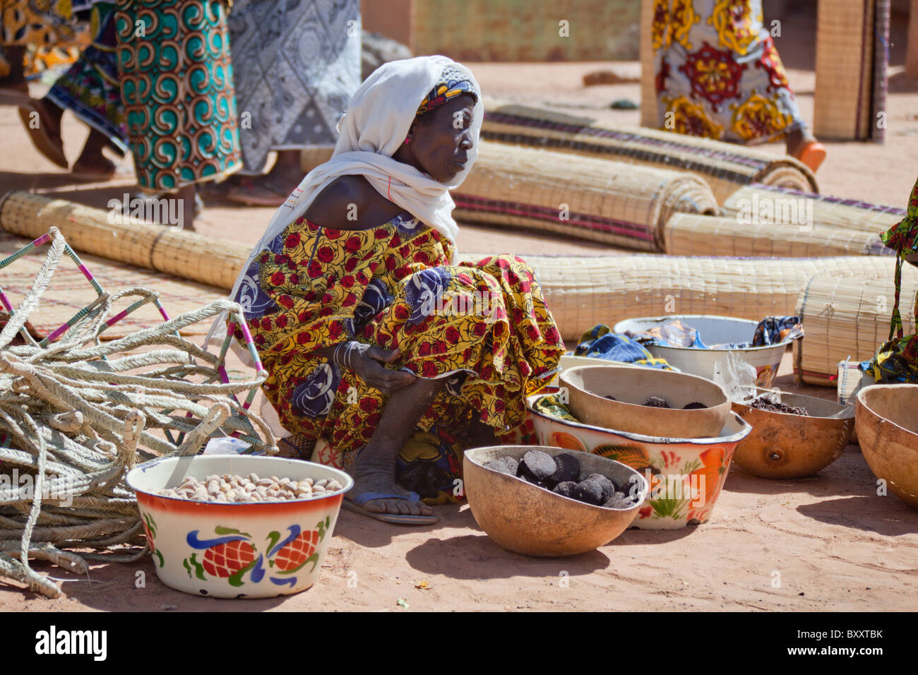 A woman sells cooking ingredients at the weekly market in Djibo in northern Burkina Faso. Stock Photo