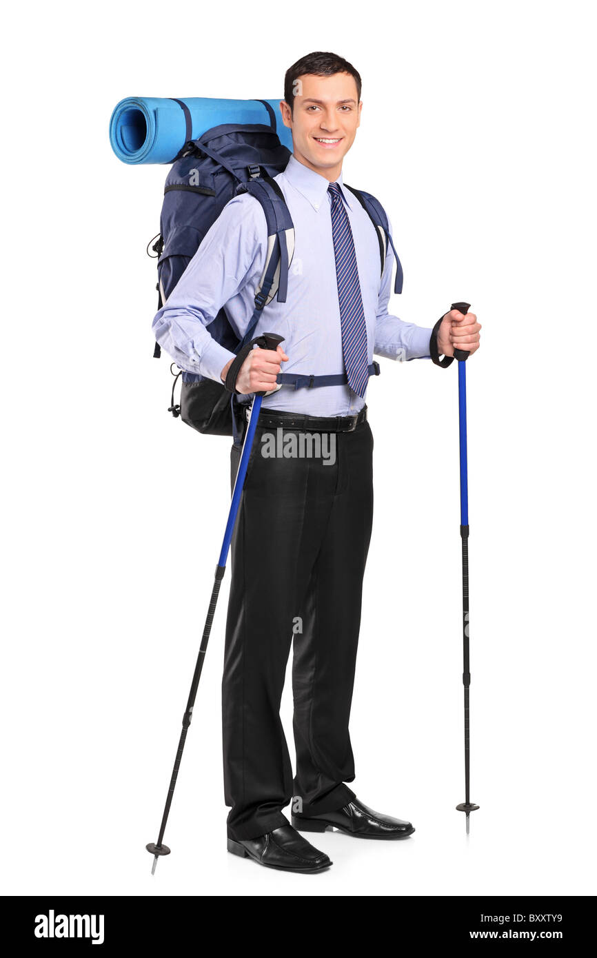 Full length portrait of a businessman in a suit with backpack and hiking poles Stock Photo