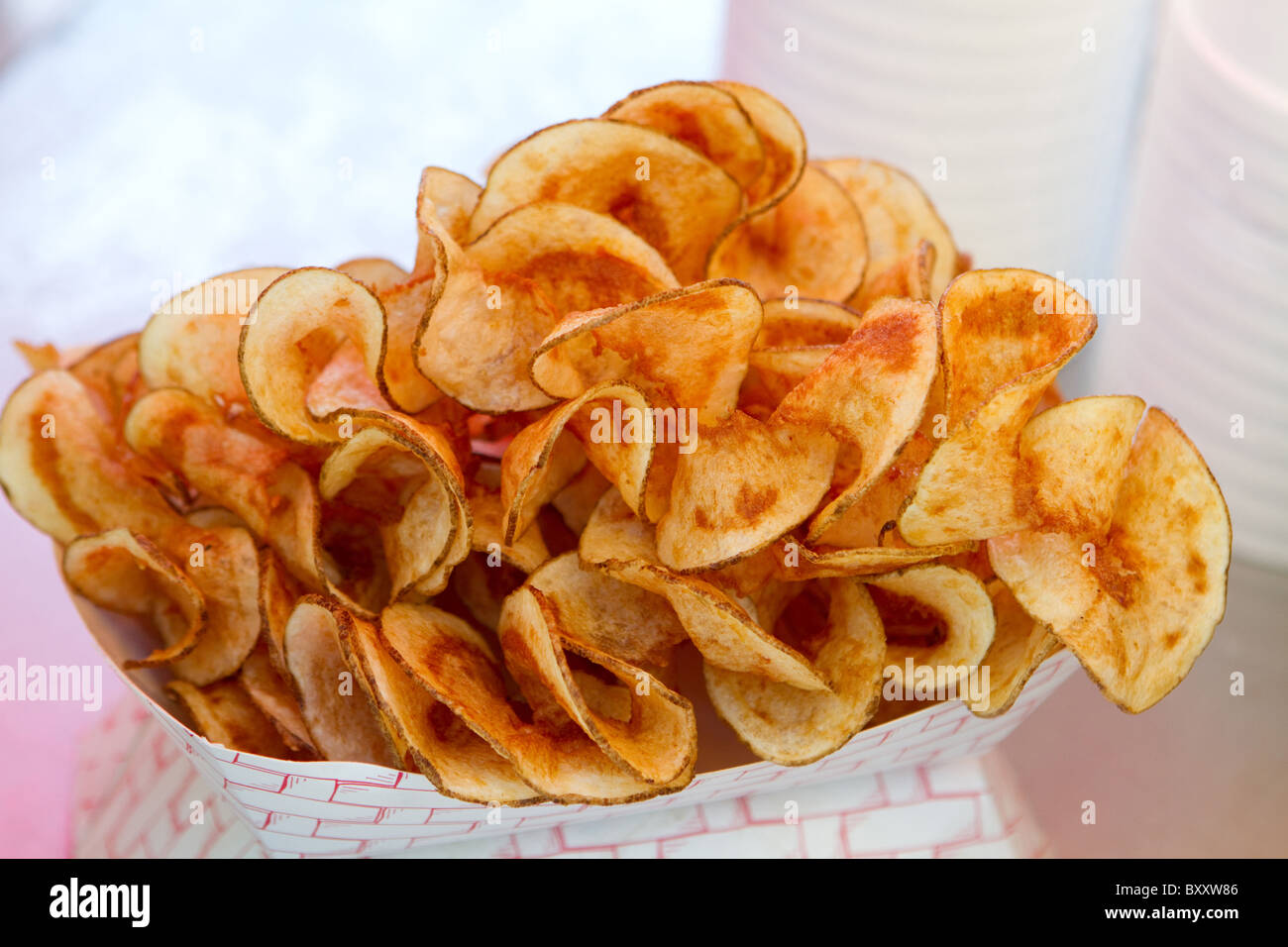Hot butterfly fries sit in a vendors window ready to be bought and eaten. Stock Photo