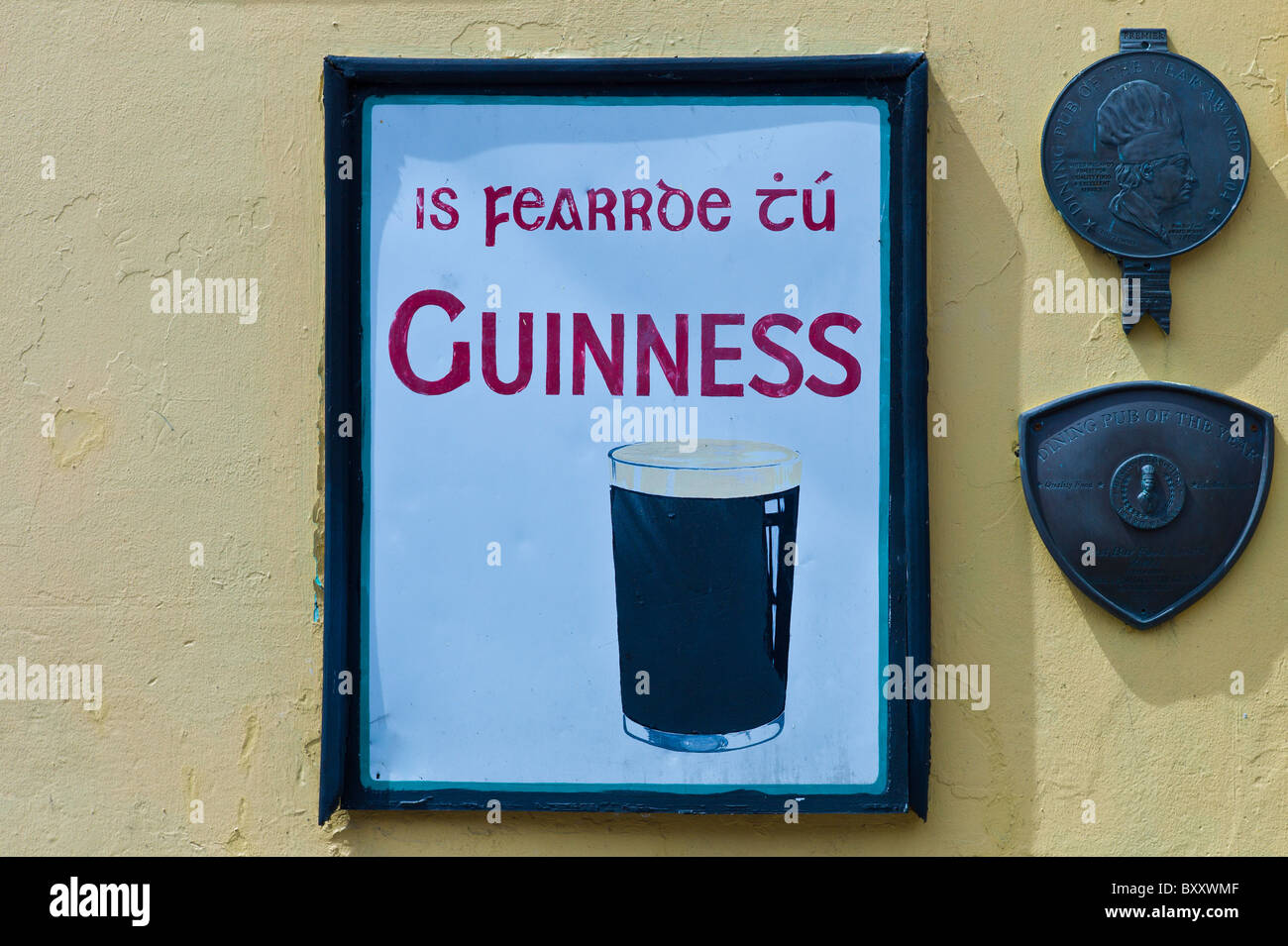 Guinness advertisement in Irish Gaelic in Timoleague, West Cork, Ireland Stock Photo