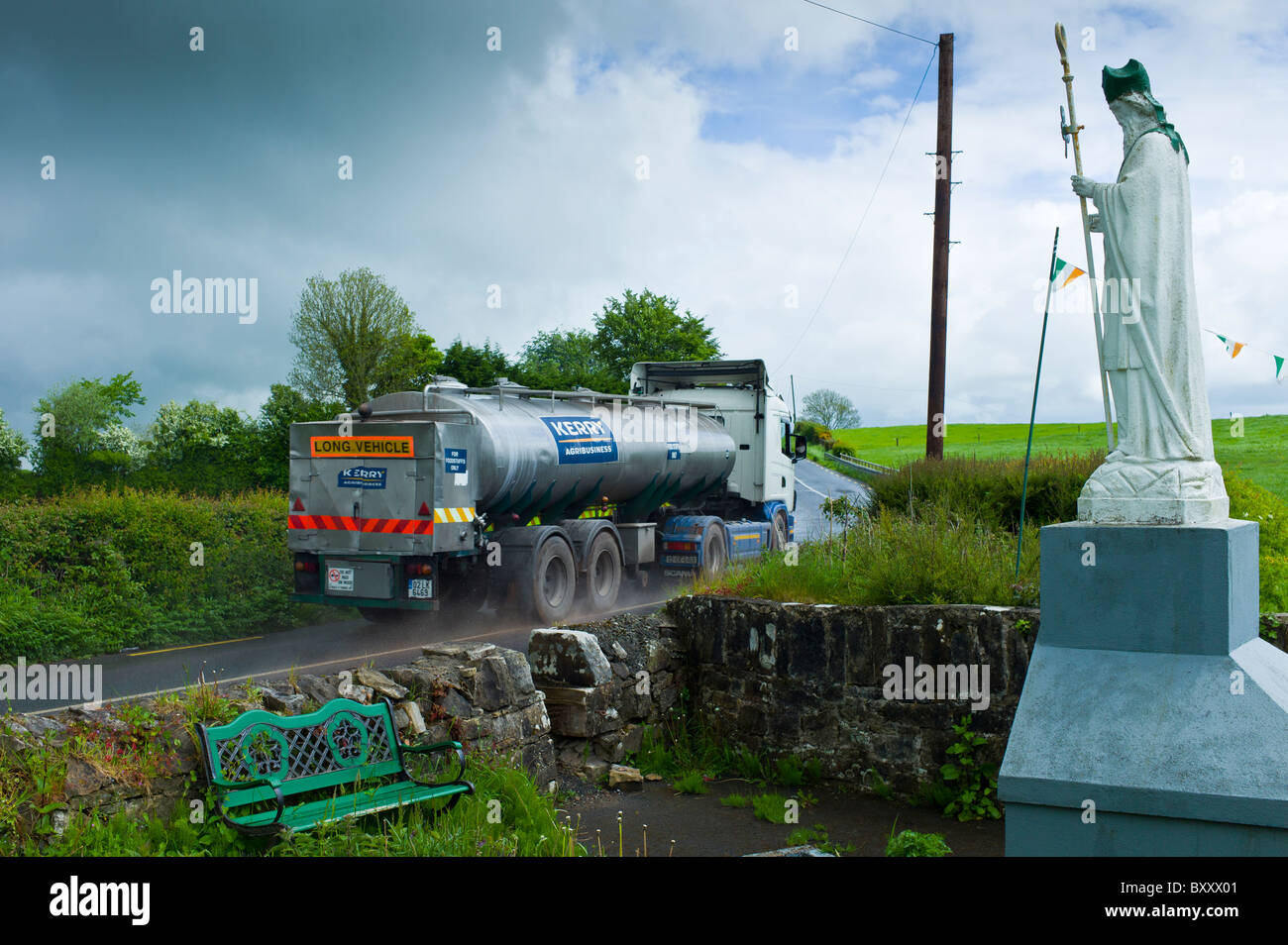 Milk tanker lorry passes religious shrine of Irish patron saint St Patrick in Ballingarry, County Limerick, Ireland Stock Photo