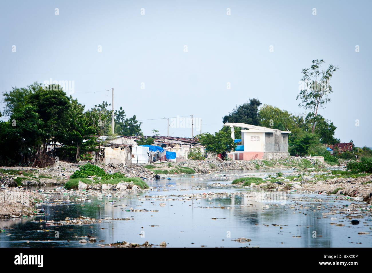 A trash filled river flows to the Caribbean sea from a suburb of Port-au Prince, Haiti Stock Photo