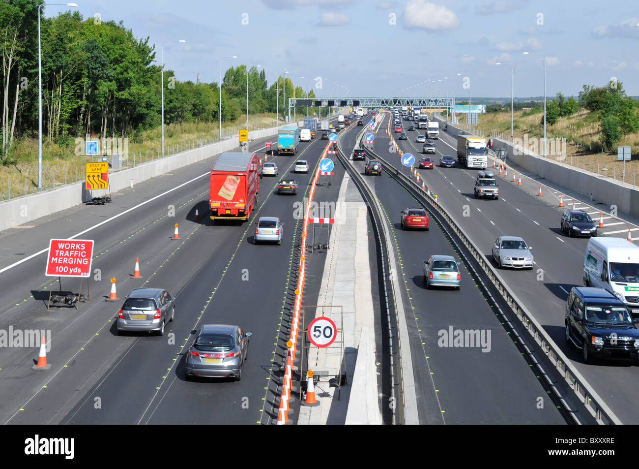 M25 motorway cross over lanes contra flow in road works widening to four lanes Civil Engineering project nears completion Essex countryside England UK Stock Photo