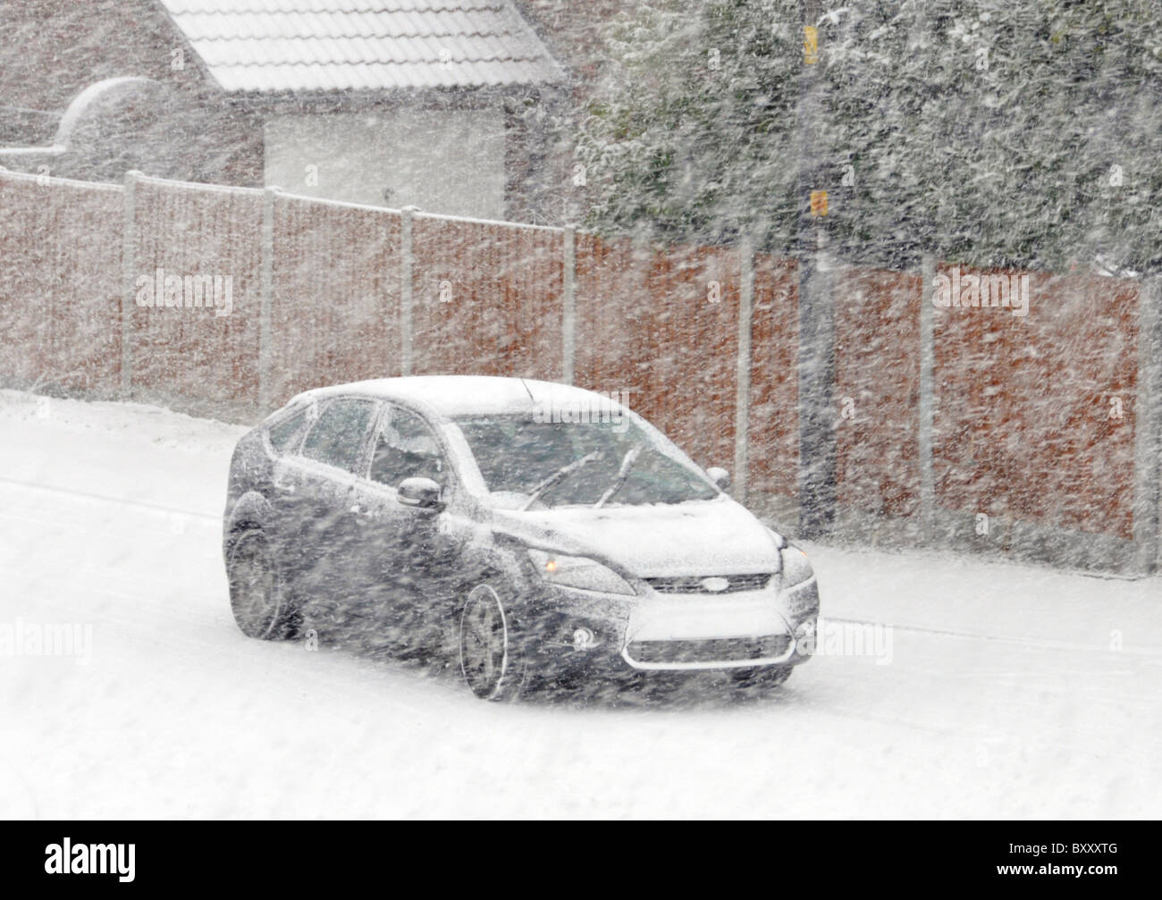 Driving car in snow blizzard Stock Photo