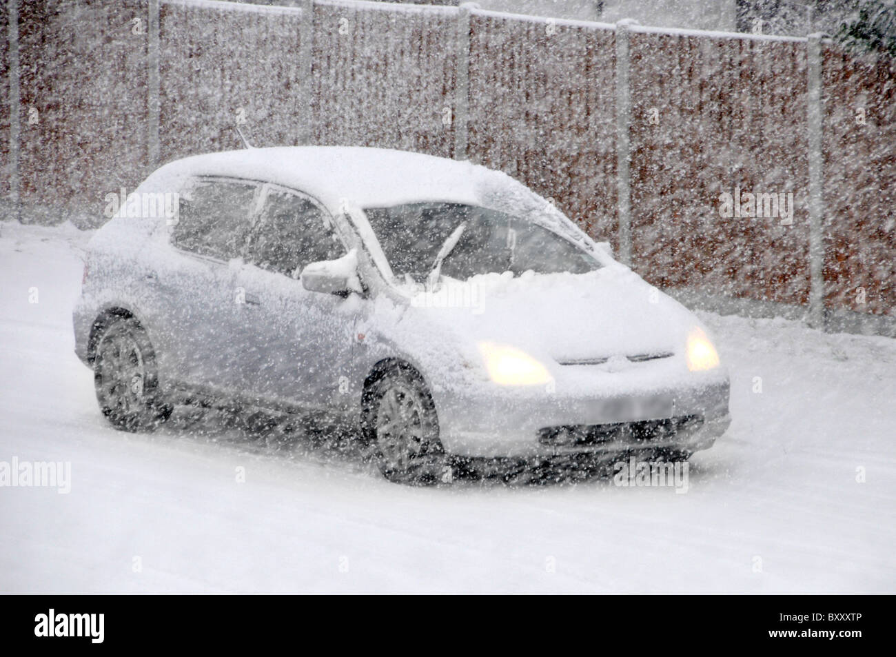 Driving car in snow blizzard Stock Photo