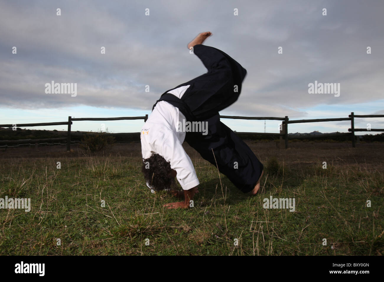 Man doing a karate roll Stock Photo - Alamy