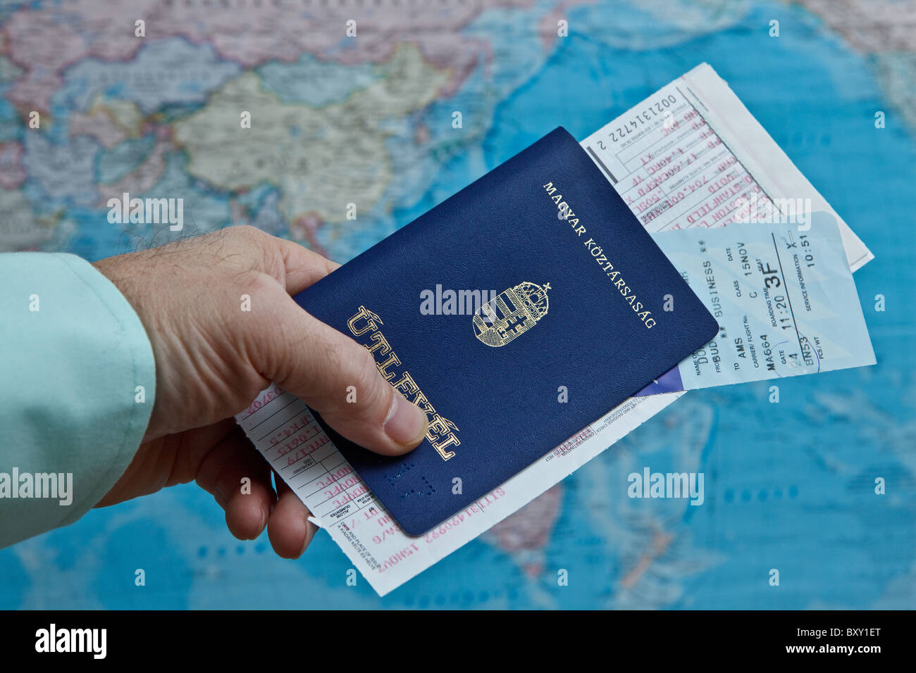 Man holding Hungarian passport, paper ticket and boarding pass Stock Photo